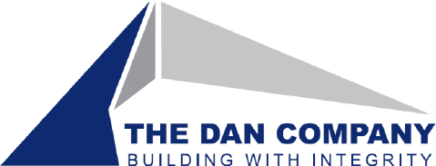 The Dan Company logo in navy blue text with gray and blue triangles.